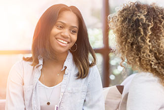 young woman sitting, talking to therapist, stock image